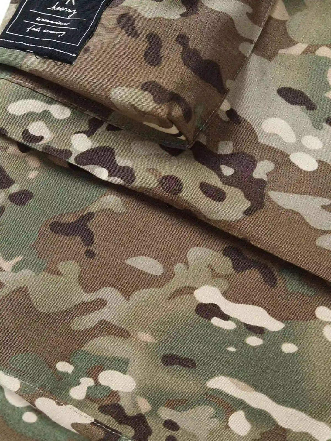 Intricate pattern detail on TALISHKO camouflage pants, emphasizing street casual style.